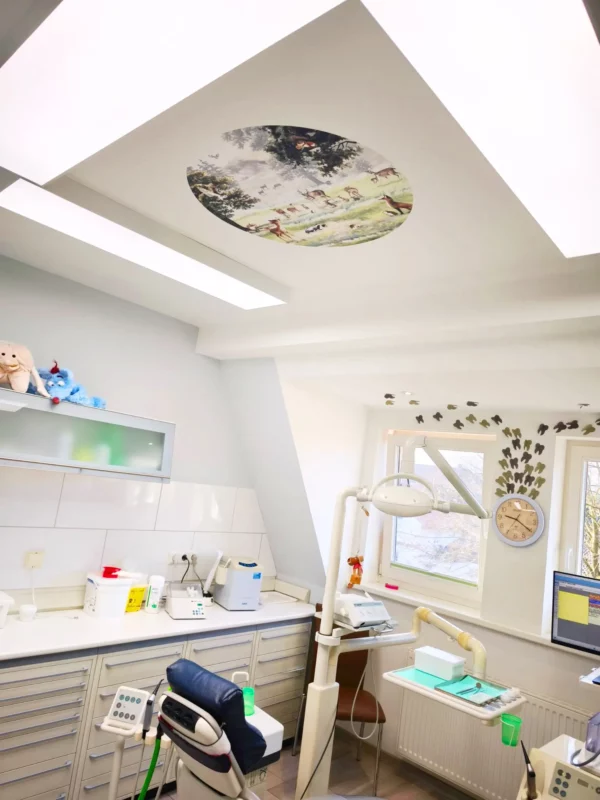 Modern dental treatment room illuminated with DL120 full spectrum daylight LED panels, providing 5000K natural light and calming ceiling design for optimal working conditions and patient comfort.
