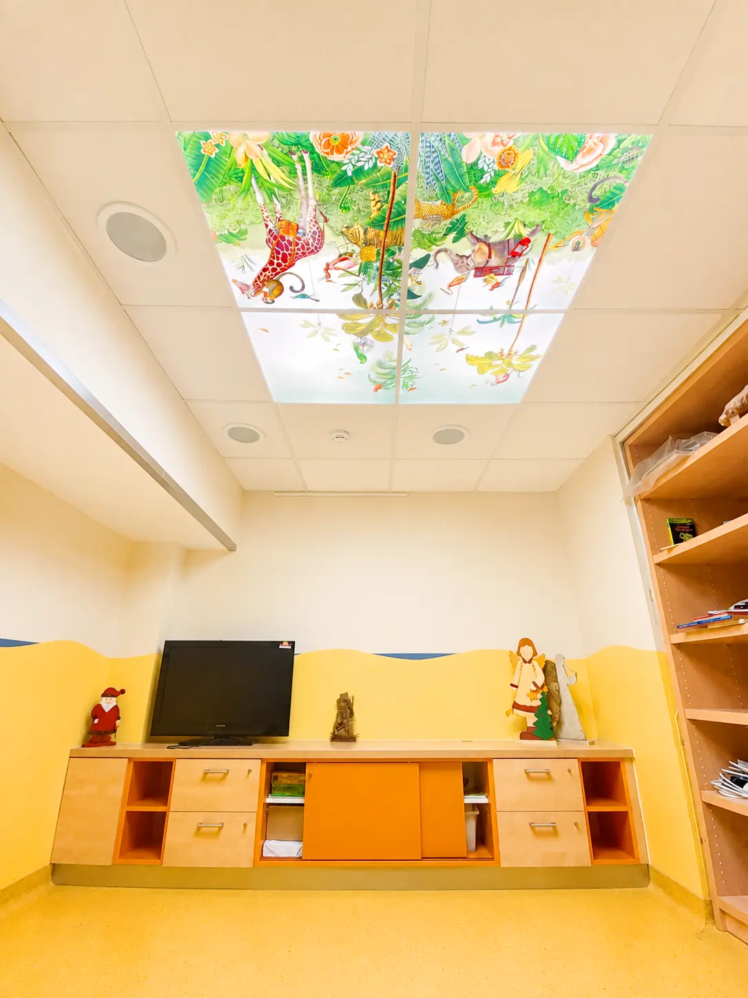 High-resolution custom LED photo panels providing bright, uniform lighting in a children's hospital ward.